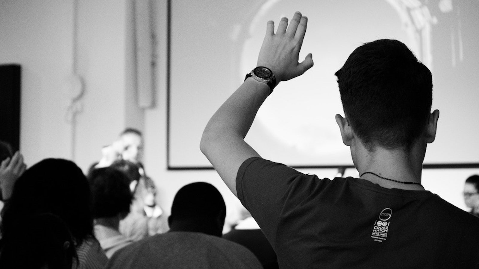 felicia-buitenwerf-Qs_Zkak27Jk-unsplash-min A man raising hand